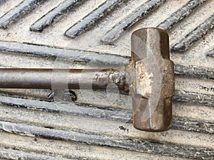 Old hammer on iron floor