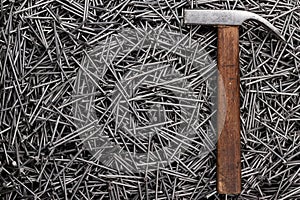 Old hammer and nails on table