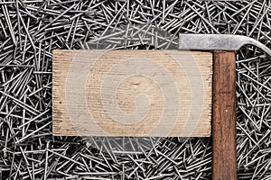 Old hammer nails and wooden board