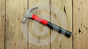 Old hammer on old wooden plank background