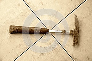 Old hammer on a tiles