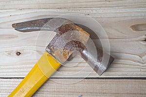 Old hammer on wooden background