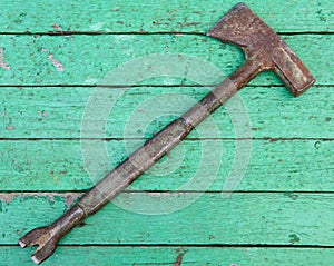Old hammer on wooden background.