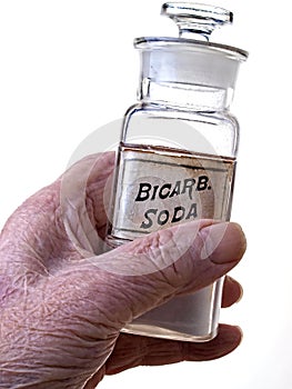 Old Hand Holding Bicarb Bottle