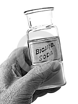 Old Hand Holding Bicarb Bottle
