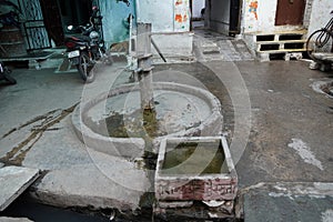 Old hand operated water pump and water containers in rural India. Hand water pump in old city. Very Old Vintage Hand Manual Pump