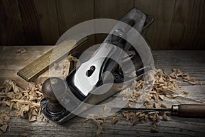 Old hand plane on carpenter workbench