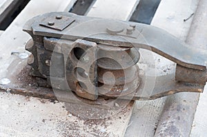 Old hand tool for bending pipe is fixed on a tree.