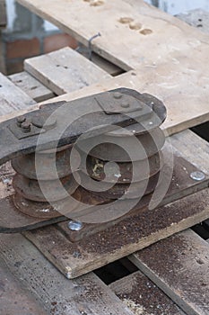Old hand tool for bending pipe is fixed on a tree.