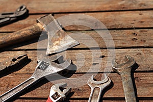 Old hand tool on a wooden surface. Tools for repair and construction