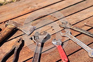 Old hand tool on a wooden surface. Tools for repair and construction