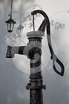 Old hand water pump and a lantern