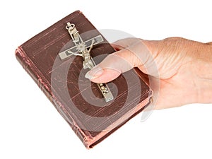 Old hand (woman) holding a very old bible