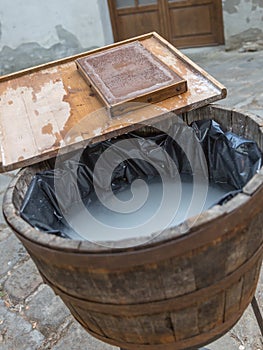 Old handcraft papermaking process with water, bucket and wooden sieve photo