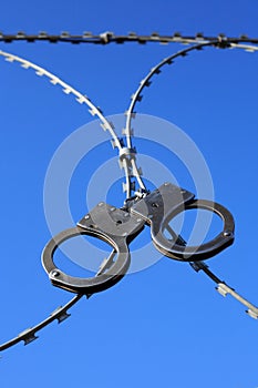 Old Handcuffs On Razor Wire