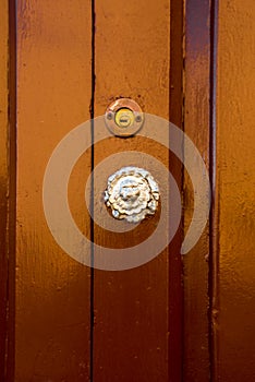 Old handle on the wooden door