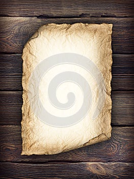 Old handmade paper sheet on wooden background