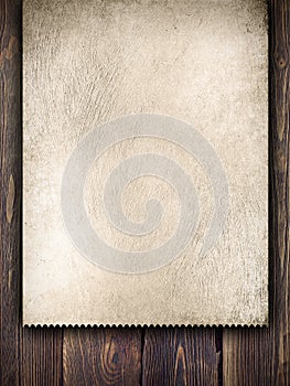 Old handmade paper sheet on wooden background