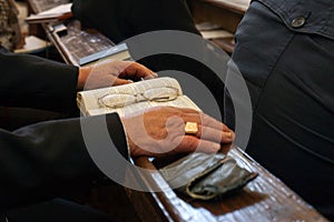 Old hands with Bible and glasses