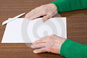 Old hands with blank paper