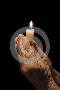 Old hands with a candle