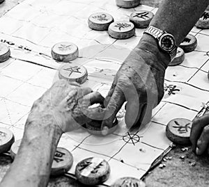 Old hands playing board game