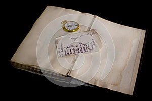 Old handwritten sheet and a pocket clock