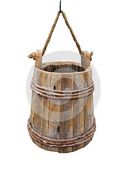 Old hanging wooden bucket isolated