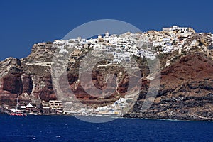 The old harbor and town Oia on Santorini slopes