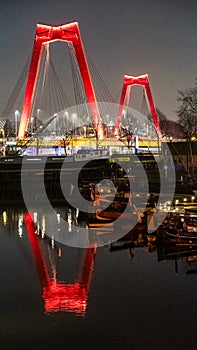 Old Harbour Rotterdam at night with the Willemsbrug reflected in the water