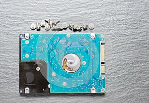 Old hard disk drive on black background