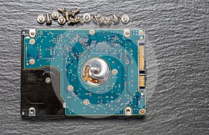 Old hard disk drive on black background