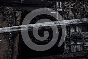 An old hatch in the floor of an abandoned pier.