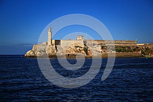Old Havana, Cuba. Castillo De Los Tres Reyes Del Morro, a fortress at the entrance to the bay. Evening view from Malecon
