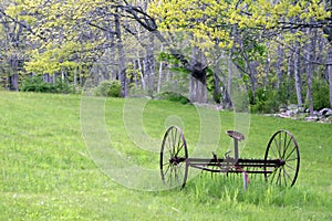 Old Hayrake 2 - rusted, in a field in Spring