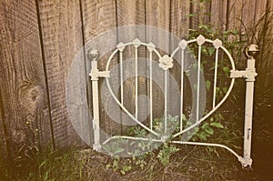 Old heart-shaped white wrought iron headboard
