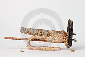 Old heating element for heating water in domestic water heaters and boilers on white background. Copy space