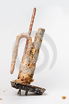 Old heating element for heating water in domestic water heaters and boilers on white background. Copy space. Vertical orientation