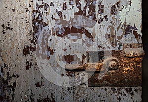 Old heavy bolted rusty door hinge lock