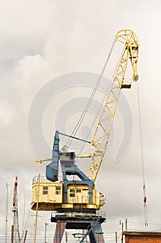 Old heavy harbor jib crane.