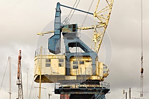 Old heavy harbor jib crane.