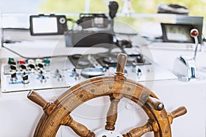 The old helm on a modern ship. The ship's wheel, and all control dash board.