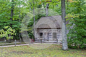 Old Hessler log cabin was built in the 1850s & sits near the Mission Point lighthouse on Lake Michigan near Traverse City, Michiga photo