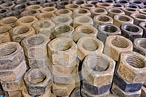 Old hexagonal bolts stacked in tiers