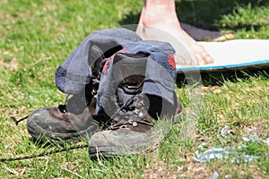 Old hiking boots with untied laces stand