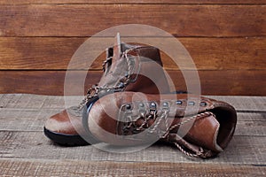 Old hiking boots on wooden background