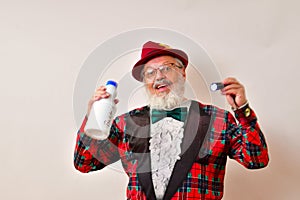 Old hipster holding up a bottle of bleach and a UV lamp