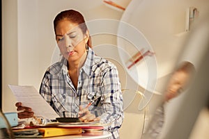 Old Hispanic Woman Filing Forms For Tax Return At Home