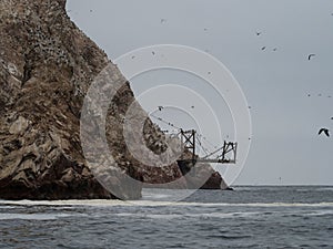 Old historic abandoned bridge ruins at Islas Ballestas Islands pacific ocean rock formation peruvian booby Paracas Peru