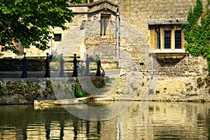 Old historic building situated on the edge of a tranquil body of water, Abingdon